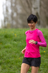 woman in pink running top enjoying a peaceful jog in nature