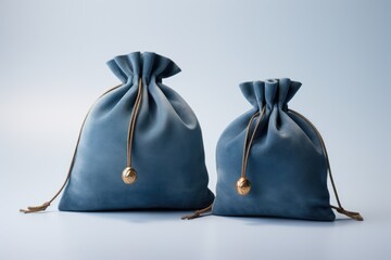 Two Blue Fabric Drawstring Bags on Light Background - obrazy, fototapety, plakaty