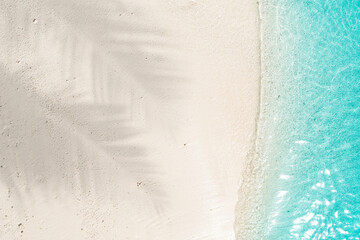 Summer vacation concept with palm shadow on untouched tropical white sand beach