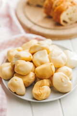 Smoked mini scamorza cheese. Traditional italian cheese on plate on white table.