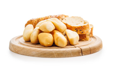 Smoked mini scamorza cheese. Traditional italian cheese on cutting board  isolated on white background.