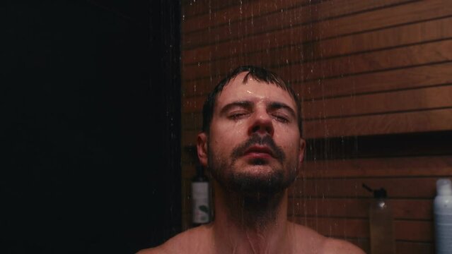 Caucasian man taking shower at home