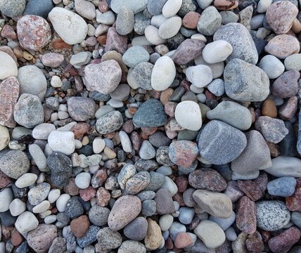 colorful pebble stones on the seashore as a background