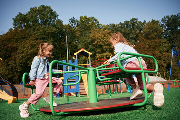 Autumn season. Kids are having fun on the playground