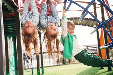 Beautiful sunlight. Kids are having fun on the playground