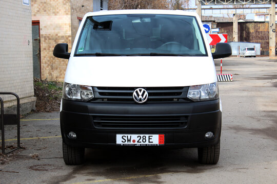 Vinnytsia, Ukraine; February 23, 2024. White Volkswagen Transporter Caravelle Multivan T6 at the city street. German Van Volkswagen Transporter. Business class transfer. Front view.
