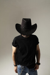 Vertical portrait of stylish mature man wearing hat and posing indoor. Isolated.