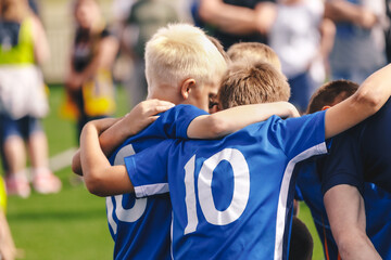 Children in Sports Team. Friends on a Soccer Team. Male Football Players Huddling Together in a...