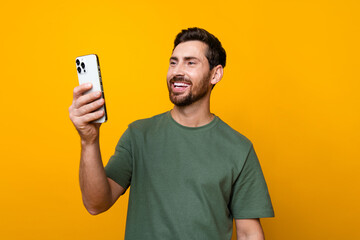 Photo of attractive young man instagram twitter facebook telegram dressed stylish khaki clothes isolated on yellow color background