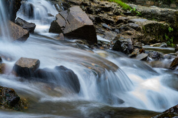 Fototapeta premium small waterfall with a small lake near Bhimtal. Landscape view of a small waterfall in the mountains. crystalline waterfall.