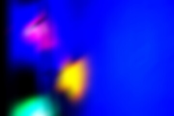 Defocused neon lights. Light flare. Futuristic led disco illumination. Blur ultraviolet magenta pink purple blue yellow green color radiance on dark abstract background. Empty copy space