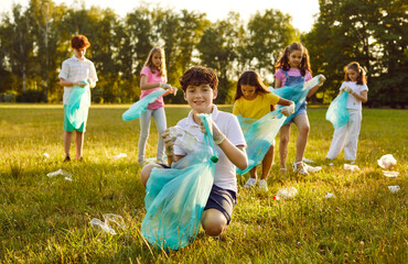 Children volunteers collect garbage to make the area a nice place at a social charity ecology event...