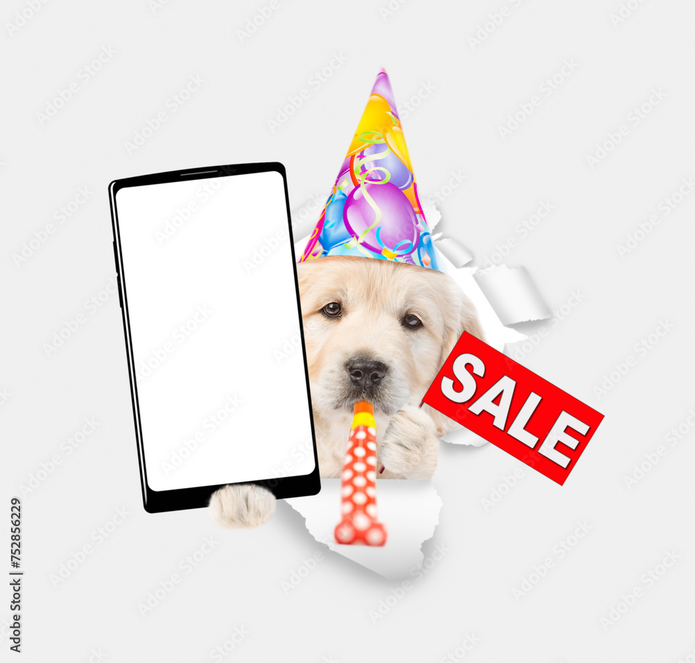 Poster golden retriever puppy wearing party cap shows big smartphone with white blank screen in it paw and 