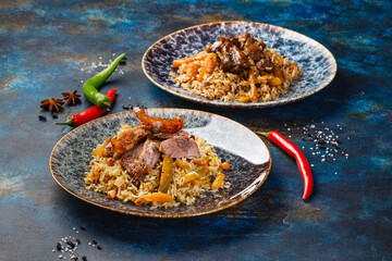 Pilaf with lamb meat in large dish,