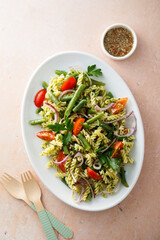Healthy pasta salad with tomato, pesto sauce and green beans