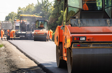 Compactor roller during road construction at asphalting work