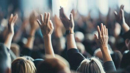 Hands of diverse audience raised in unison at an engaging public event. - Powered by Adobe
