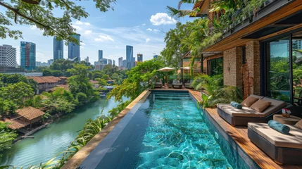 Papier Peint photo Etats Unis A rooftop pool and lounge area surrounded by lush greenery and overlooking the bustling city below. Soak up the sun in style
