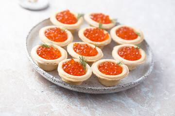 Red caviar served in tartlets