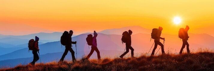 Fototapeta na wymiar Adventurous group of hikers enjoying a mountain sunset trek in summer nature together.