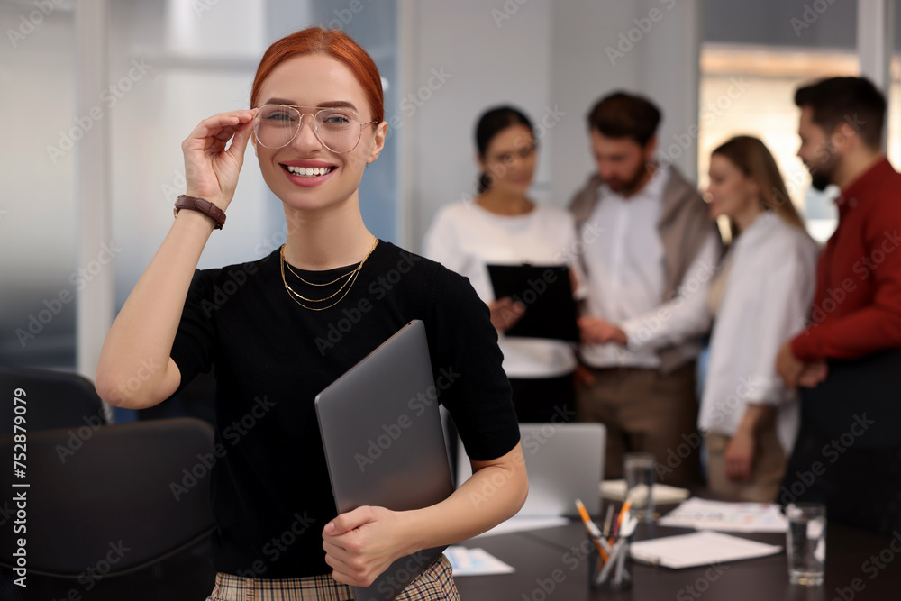 Wall mural team of employees working together in office. happy businesswoman with laptop indoors