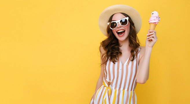 Cheerful girl with hat, striped dress and sunglasses holding ice-cream.