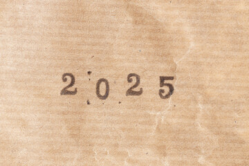 2025 ink rubber stamp on crumpled brown paper