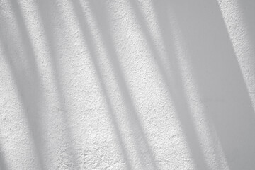 Textured white wall with abstract shapes, lines, silhouettes during sunny day as texture or background - 752884657
