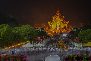 A lot of people come to worship Buddha relics celebration and do candlelight procession at Hot kham...