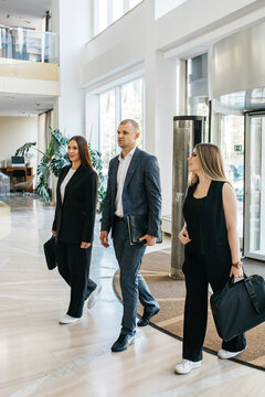 Business people enter the lobby of a business office or hotel. Concept of business negotiations, services. conducting presentations and business gatherings and business travel.