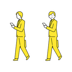 鞄を持ちスマホを見ながら歩くスーツ姿の男性.