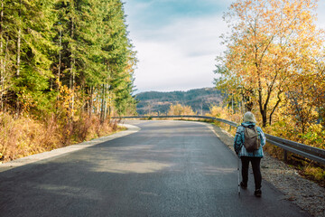 Hiking, Mature caucasian senior woman in nature for exercise, holiday walking and enjoying the mountains. Travel, retirement and an elderly man and woman on a walk in the woods or forest for trekking