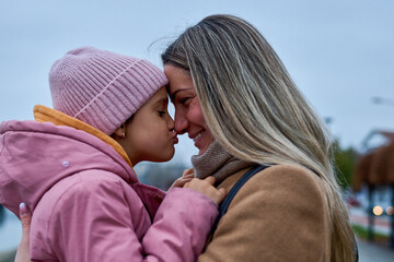 In candid pauses, the mother and daughter share hugs and kisses, creating cherished memories amid...