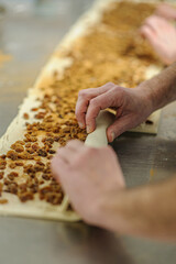 Close-up of baker's hands, bakery and pastry concept. Professional pastry chef working on a bakery business.