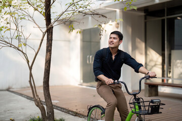 Businessman and bicycle in city to work with eco friendly transport. happy businessman professional riding a bicycle in urban street