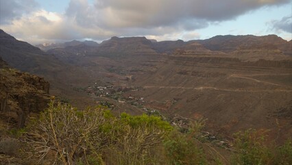 Arid and rocky mountains with dry vegetation in the hinterland of the Canary Islands due to too much heat. Global warming concept