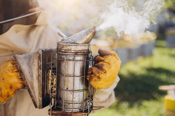 Close-up of beekeeper holding smoker in bee farm