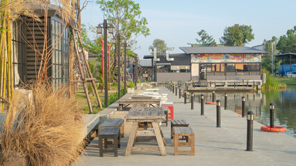 Photos of tourist attractions Model Japanese town A waterfront sitting area with wooden tables, dry...