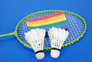 Fototapeta na wymiar Badminton shuttlecocks, rainbow colors flag on racket. Concept, sport, exercise, recreation activity for good health. Popular sport for all genders and LGBTQ+ worldwide. 