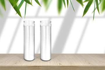 Classic candle in glass mockup shelf with light and window- shadows with fresh leaves border