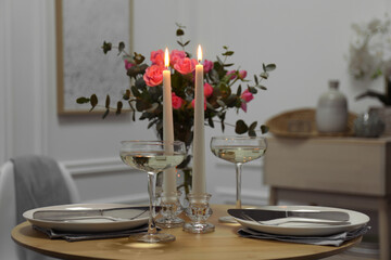 Romantic table setting with candles and flowers