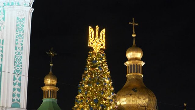 Christmas tree with coat of arms of Ukraine near Saint Sophia Cathedral or Sophia of Kiev, ancient historical monument of Kievan Rus. Today it is one of city best known landmarks