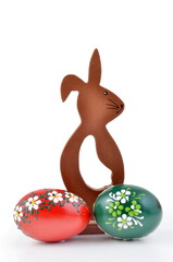 Easter eggs and wooden easter bunny isolated on white background.