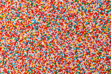 Confectionery sprinkles. Colorful background texture. Decoration for cake and bakery. Top view