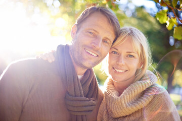 Man, woman and portrait in park environment for love anniversary in autumn weather with warm...