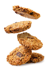 Granola cookies falling on a pile on a white background. Isolated