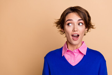 Photo of shiny excited lady dressed blue sweater open mouth looking empty space isolated beige...