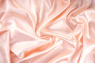 Simple beautiful satin fabric background. Gently pink pearl cream waves folded satin fabric, with...