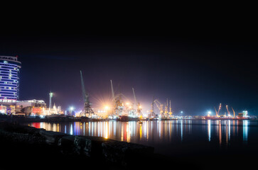 sea ​​port with ships and barges in Batumi at night