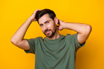 Fototapeta na wymiar Photo of cool positive guy dressed green t-shirt arms head enjoying haircare isolated yellow color background